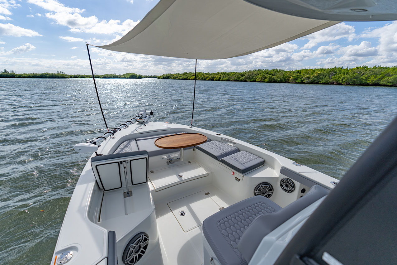 Pathfinder 2800 Hybrid bow cushions and table with sun shade.