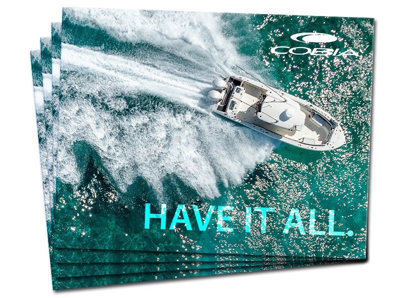 Several COBIA 2026 brochures fanned out, featuring the cover image of the 305 CC boat.